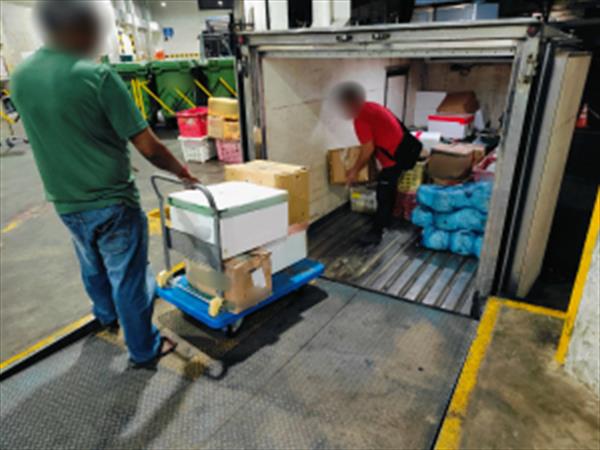 Truck drivers unloading the imports for inspection