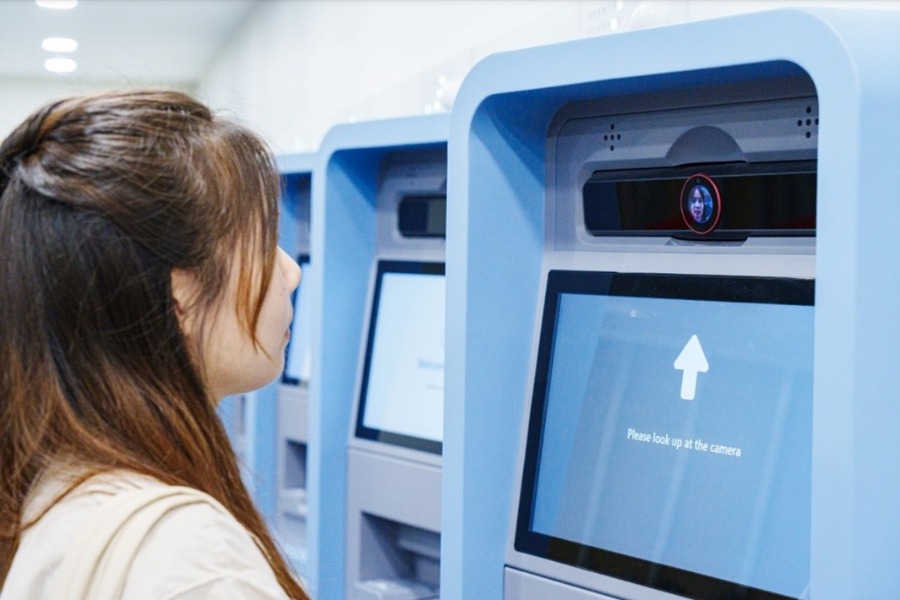 Customers input their personal identification information into the self-collection kiosk and complete their iris verification.