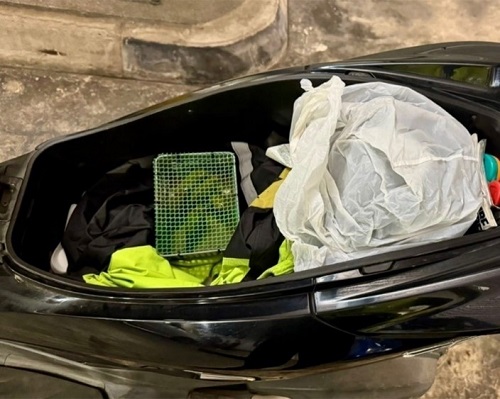 Birds discovered under a raincoat inside the motorcycle seat compartment