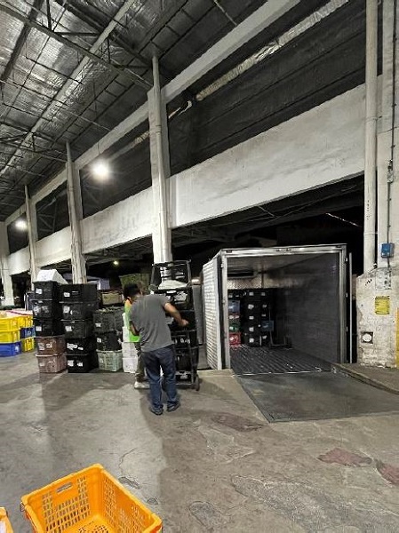 Truck drivers unload the imports for inspection