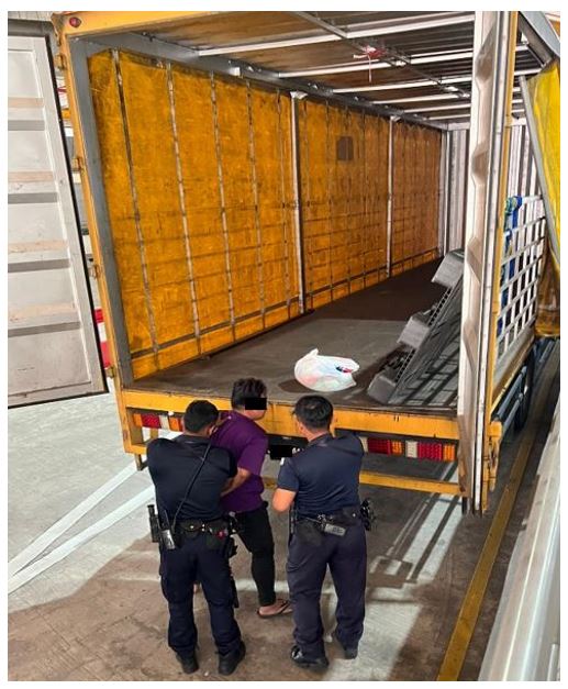 ICA officers placing the 32-year-old Malaysian man under arrest