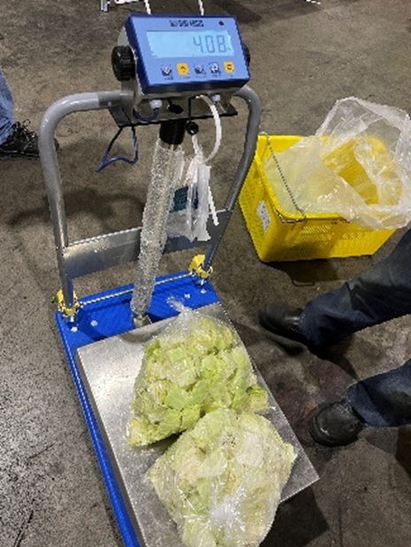 Produce is weighed and the total weight is tallied