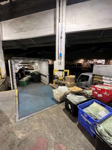Truck drivers unloading imports for inspection